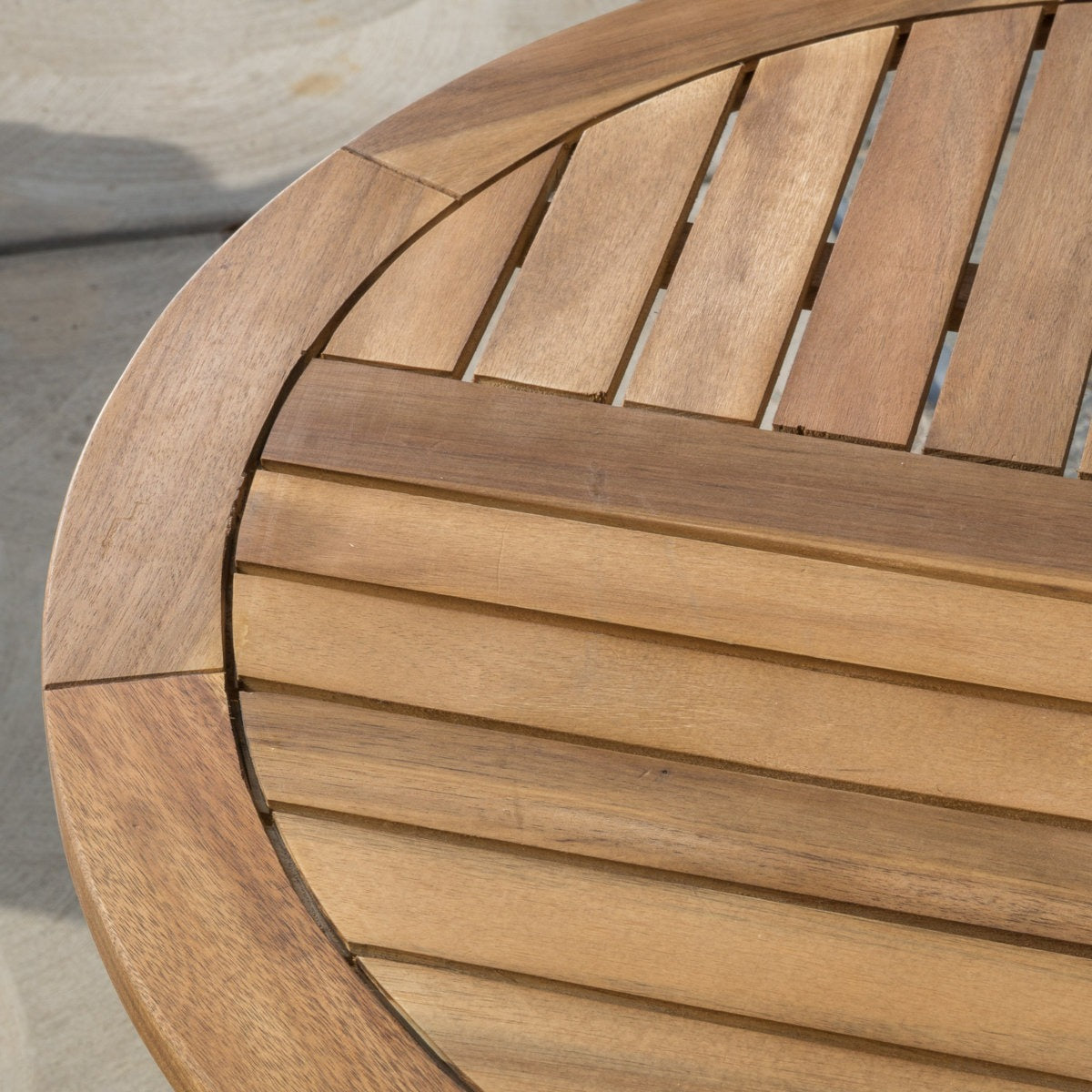 Close-up of a wooden chair with slatted backrest and seat.