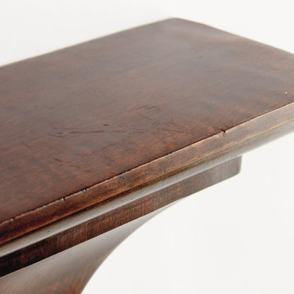 Close-up of a wooden surface with a white base on a white background