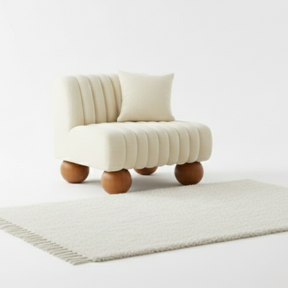 Cream-colored armchair with wooden legs on a light gray rug