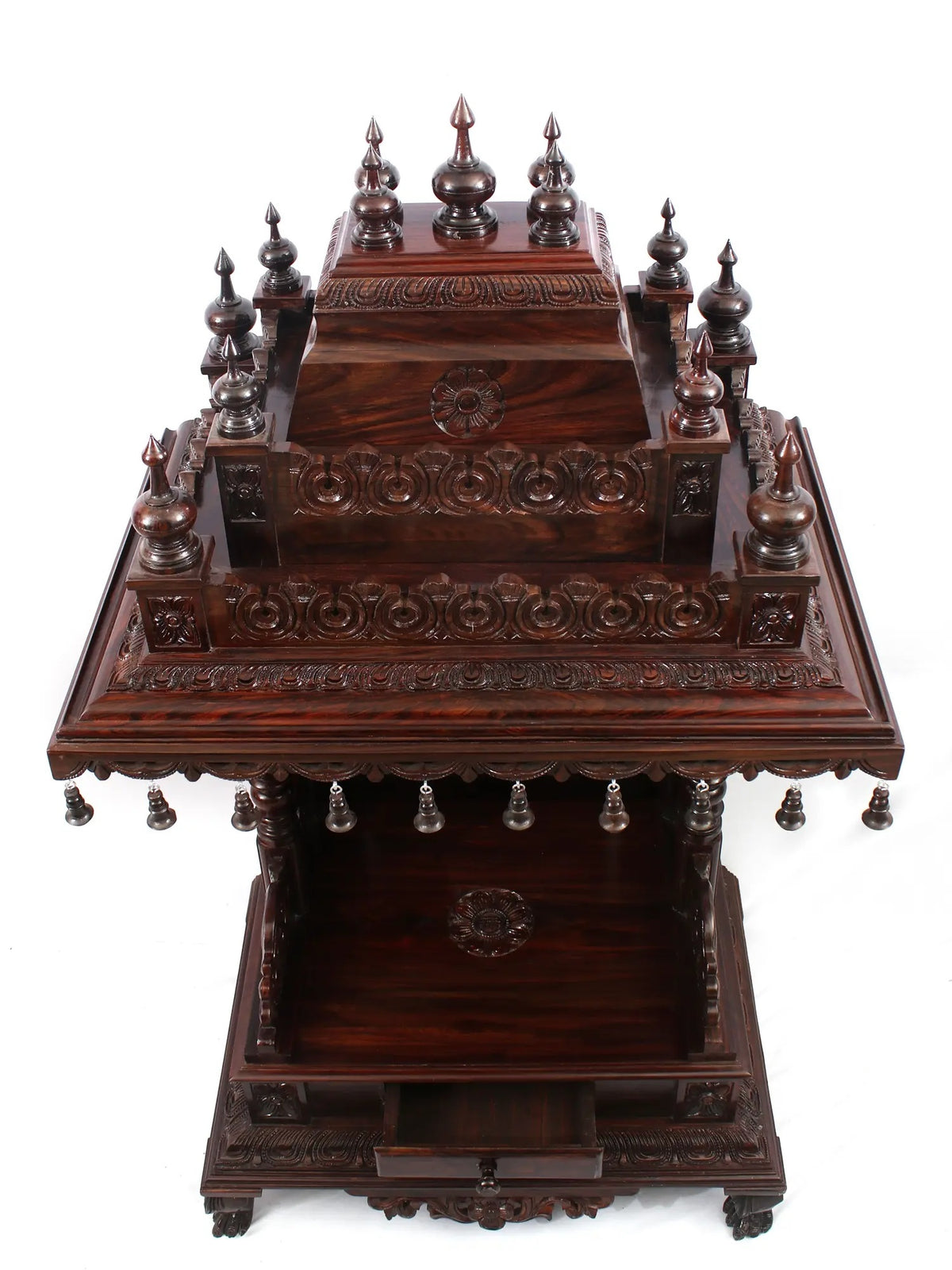 Decorative wooden altar with intricate carvings on a white background