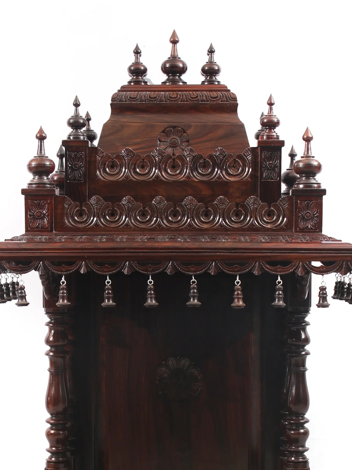 Decorative wooden structure with intricate carvings and hanging elements on a white background