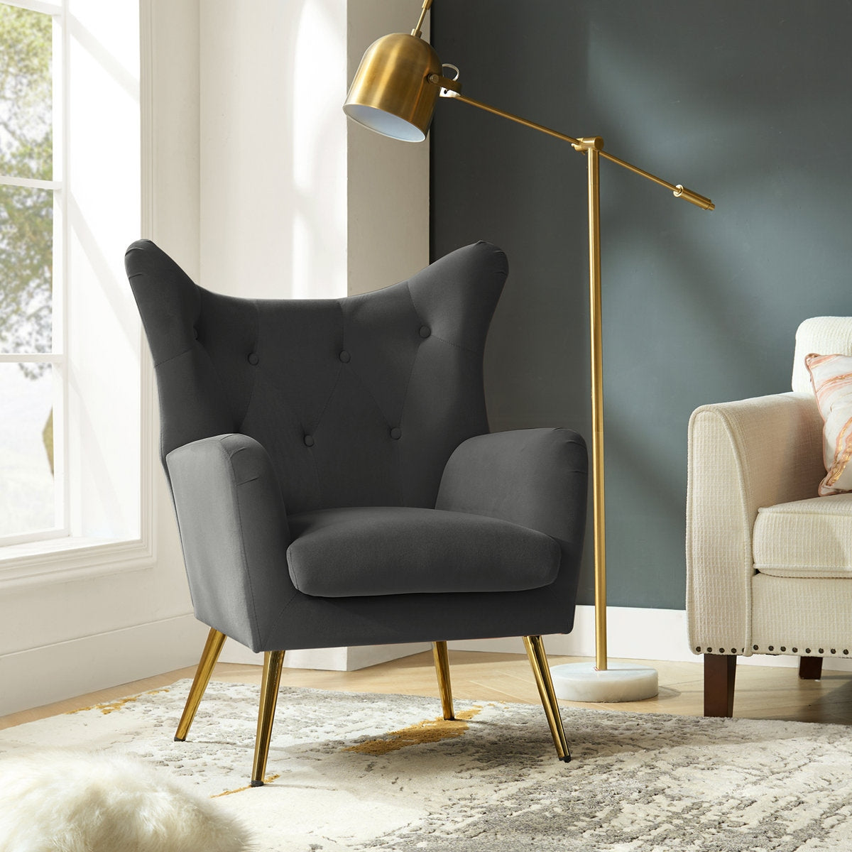 Gray armchair with gold legs in a living room setting