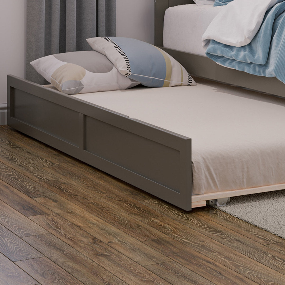 Gray bed with beige mattress and pillows on a wooden floor.