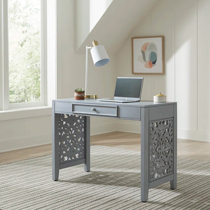 Gray desk with a laptop in a home office setting
