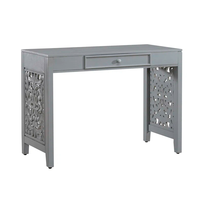 Gray desk with decorative front panel and drawer on a white background