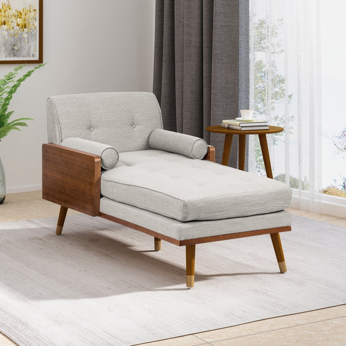 Gray lounge chair with wooden frame in a room with curtains and a plant.