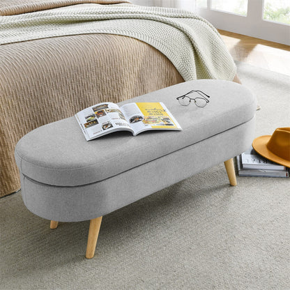 Gray ottoman with a magazine on top in a living room setting