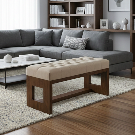 Gray sectional sofa with a beige ottoman in a living room setting.