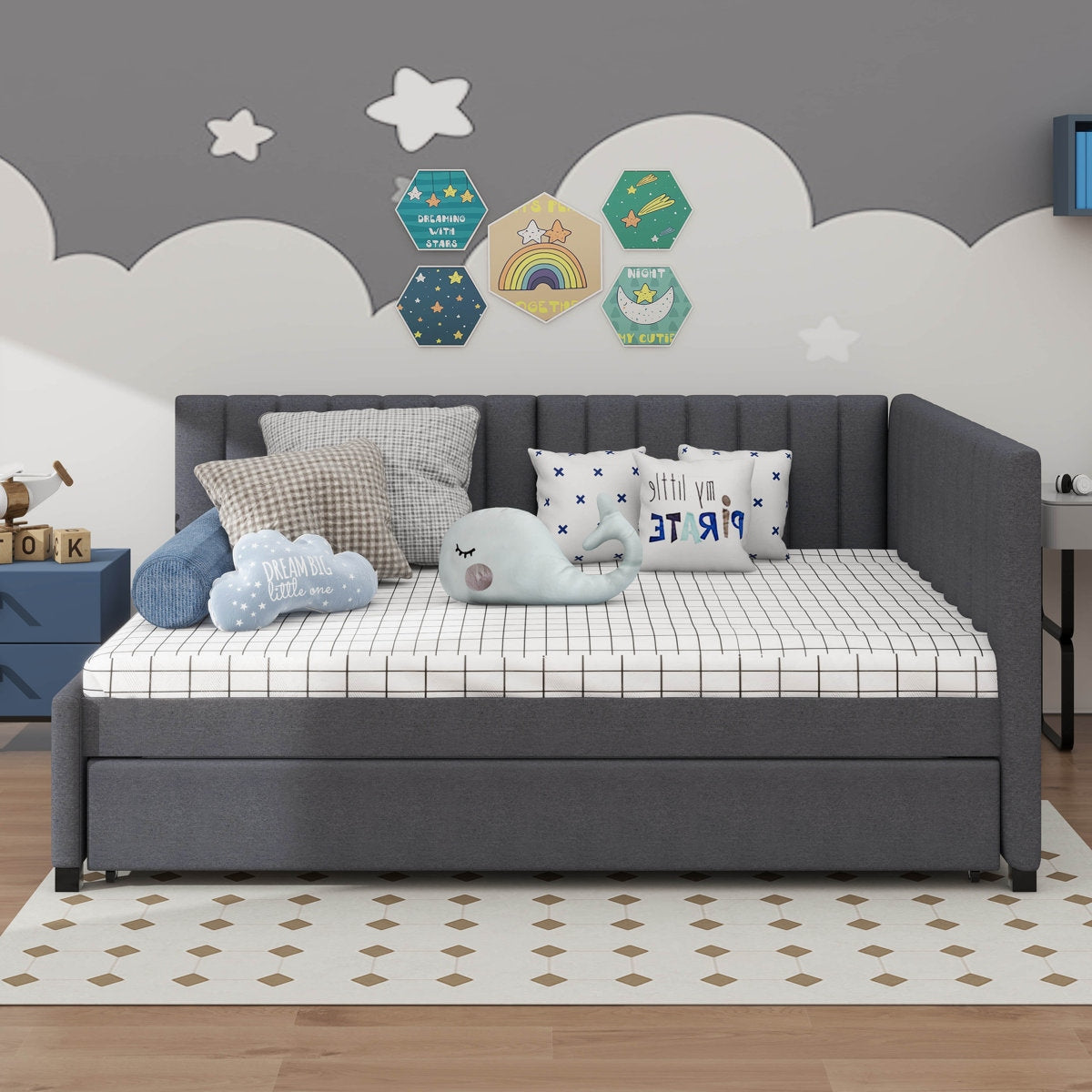 Gray sofa bed with cushions in a child-friendly room with decorative wall art.