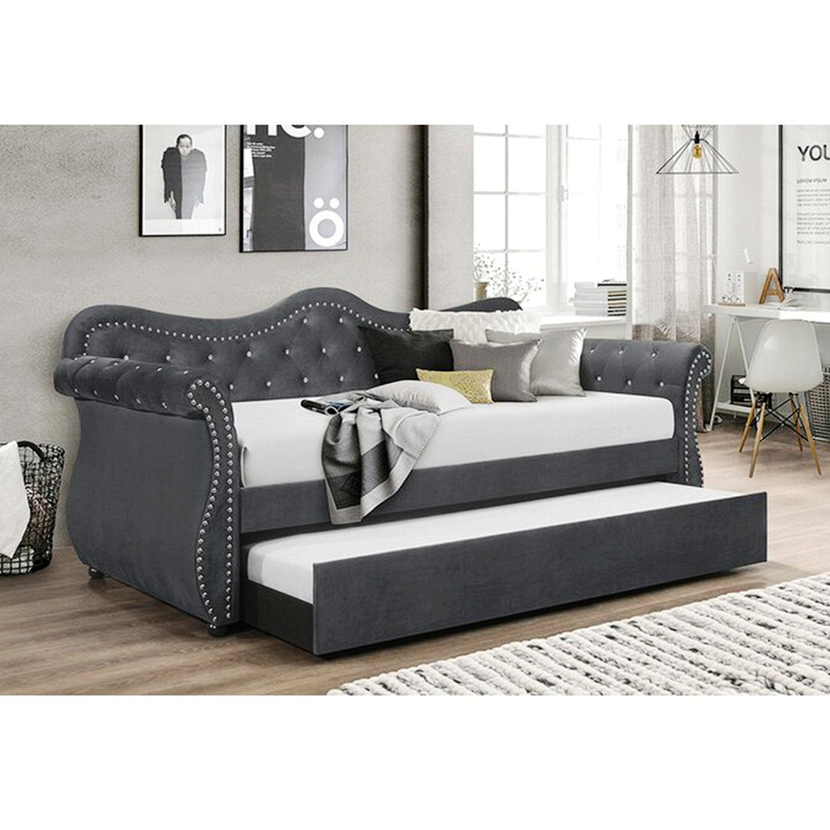 Gray upholstered bed with trundle in a room setting