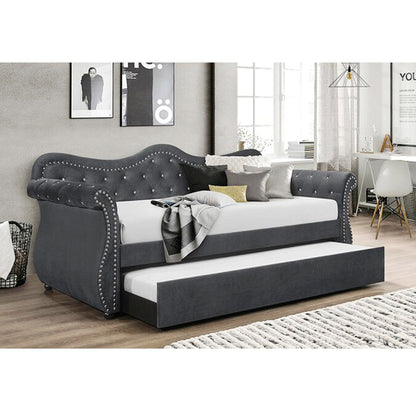 Gray upholstered bed with trundle in a room setting