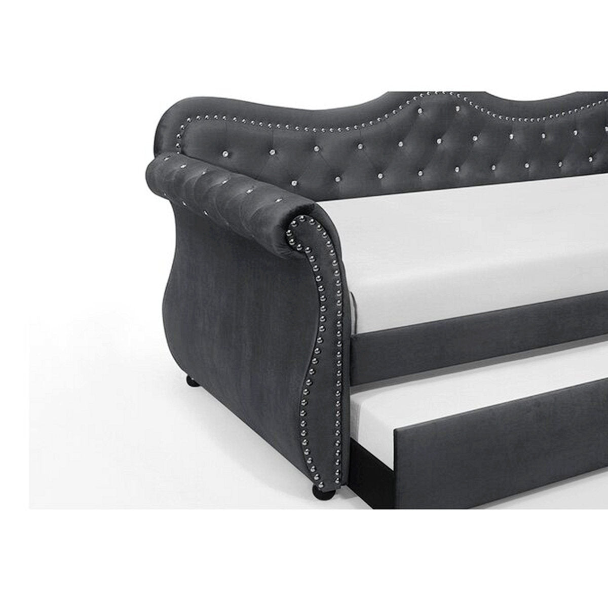 Gray upholstered bed with tufted details on a white background