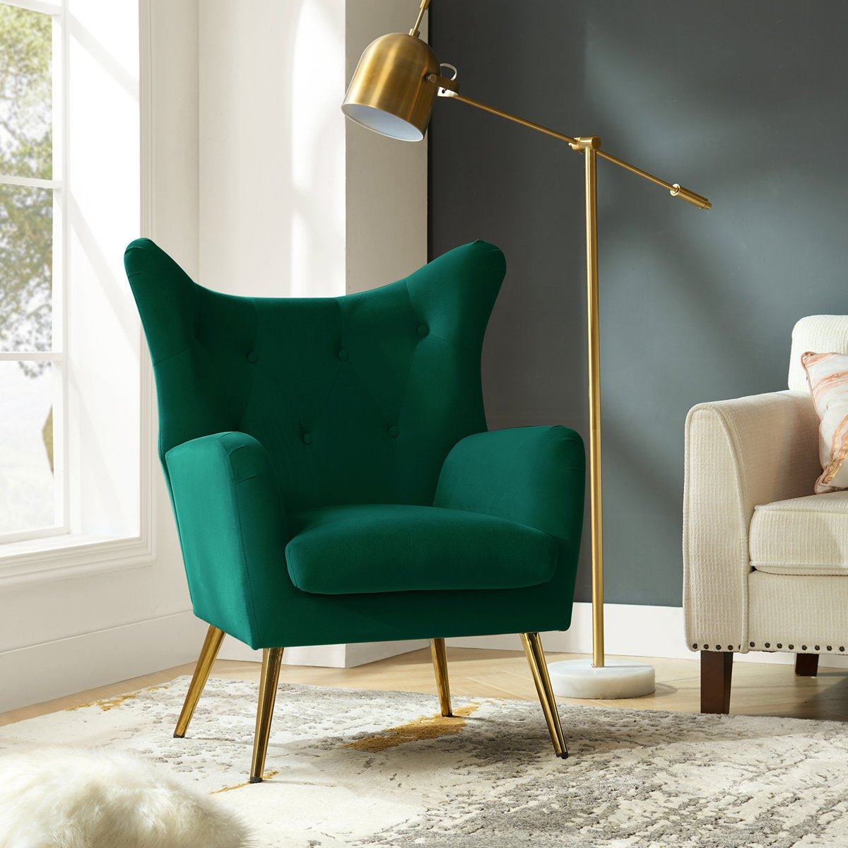 Green armchair with gold legs in a modern living room setting