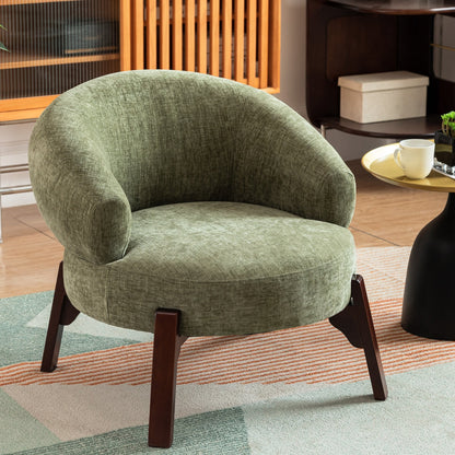 Green armchair with wooden legs in a room setting