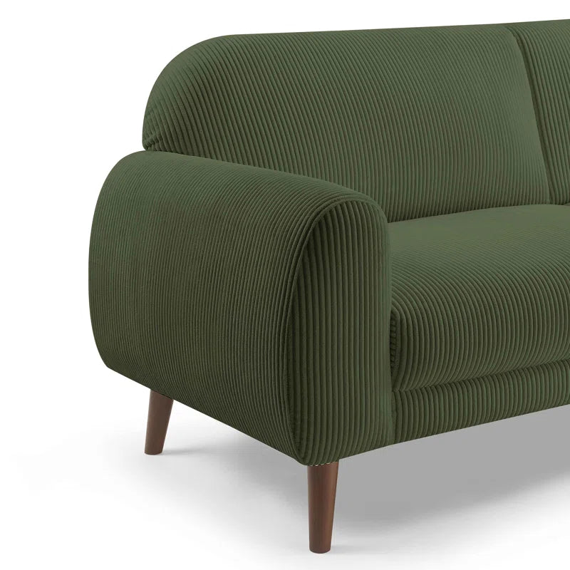 Green ribbed sofa with wooden legs on a white background