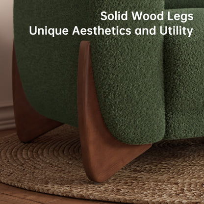 Green upholstered chair with wooden legs on a textured rug