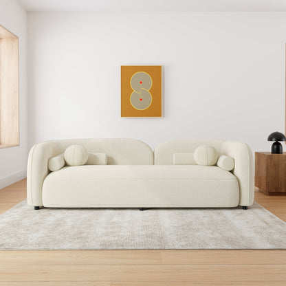 Beige sofa in a modern living room with a abstract art piece on the wall.