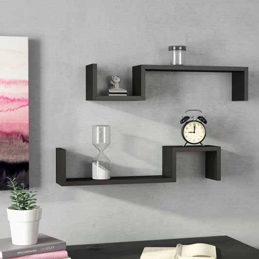Black wall shelves with decorative items on a gray wall