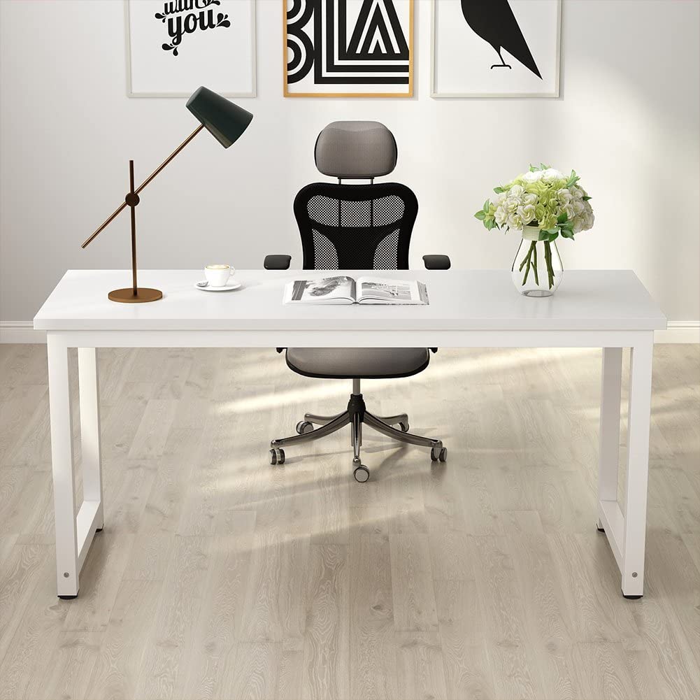 Modern office desk with chair, lamp, and decor in a bright room.