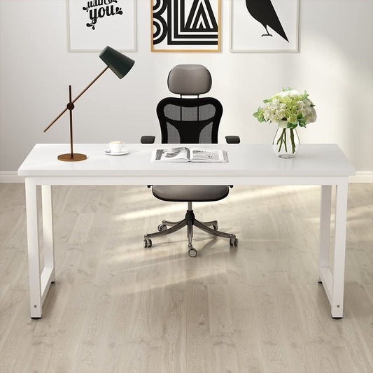 Modern office desk with chair, lamp, and decor in a bright room.