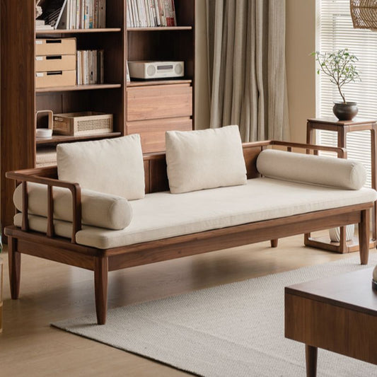 Wooden sofa with white cushions in a living room setting