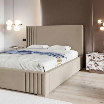 Beige upholstered bed in a modern bedroom setting with neutral walls and decor.