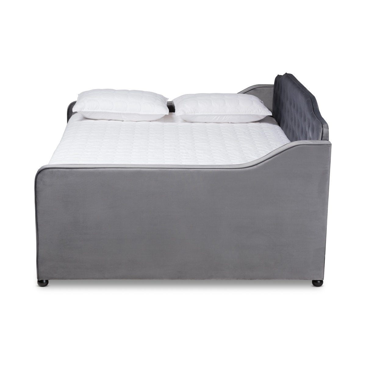 Gray upholstered bed with white bedding on a white background