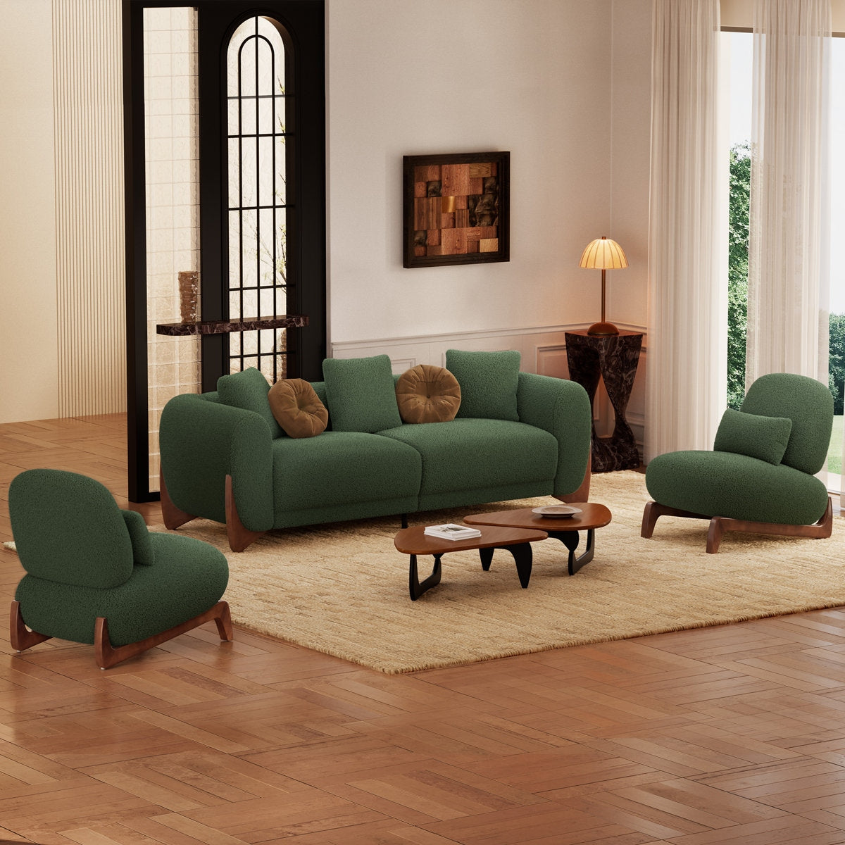 Green sofa and chairs in a living room with wooden floor and large windows.