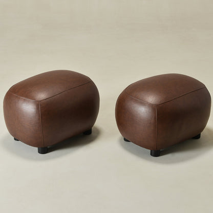 Two brown leather ottomans on a beige background