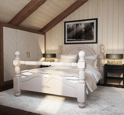 White wooden bed in a bedroom with wooden beams and framed picture on the wall.