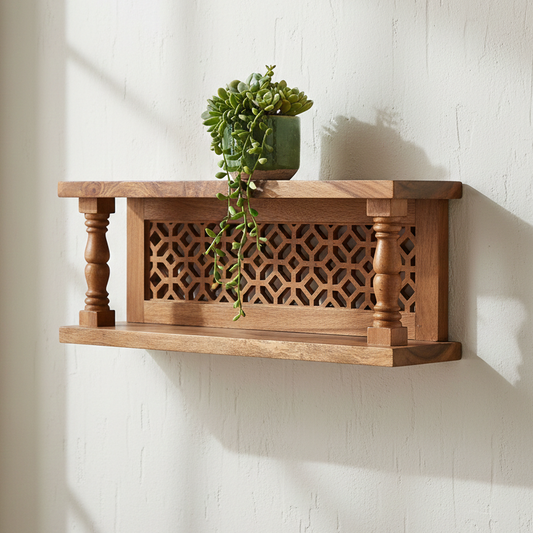 Wooden wall shelf with decorative patterns holding a potted plant against a white wall.