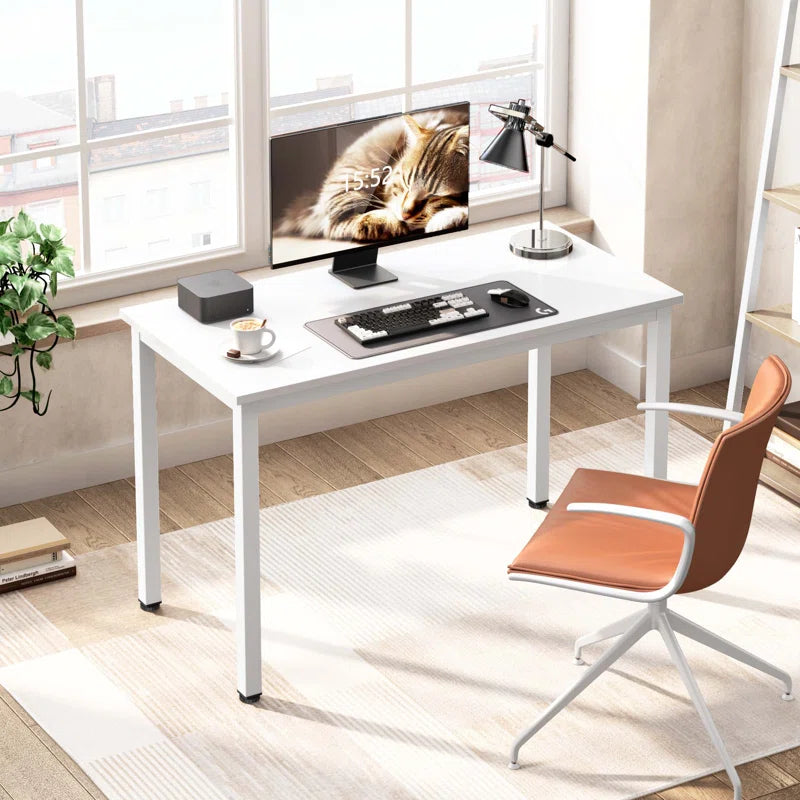 A modern white computer desk with a  office chair, set in an office environment with decorative items and a potted plant. The desk has a wooden tabletop and metal frame.