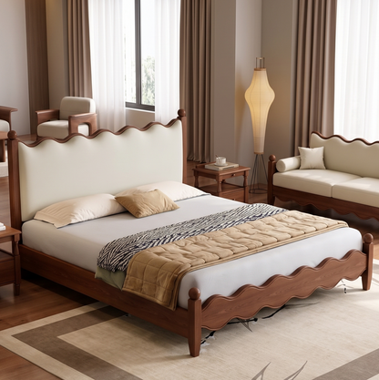 Bedroom with wooden bed, beige sofa, and lamp in a well-lit room.