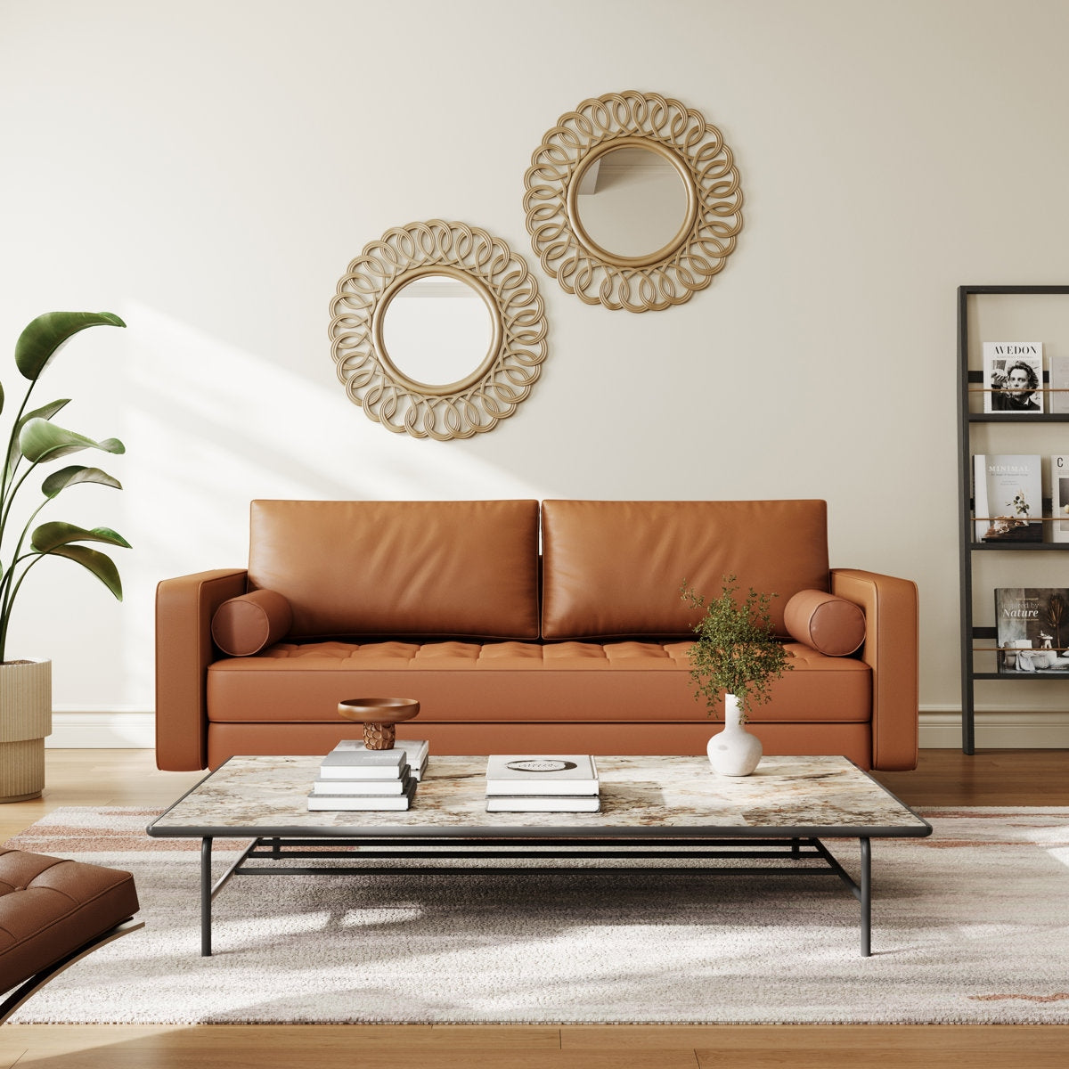 Living room with a brown leather sofa, coffee table, and decorative mirrors.