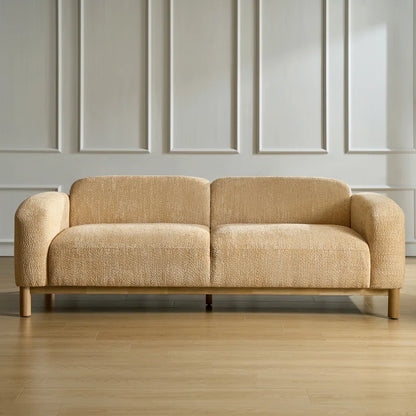 Beige sofa in a room with panelled walls and wooden floor