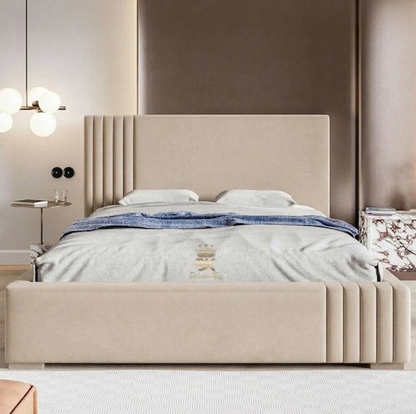 Beige upholstered bed in a modern bedroom setting with neutral walls and decor.