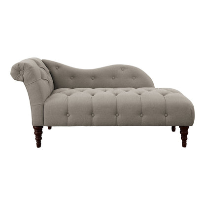 Gray tufted chaise lounge on a white background