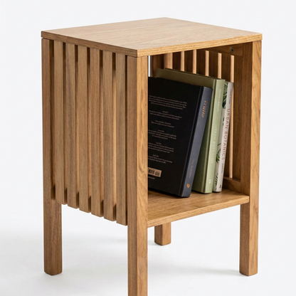 Wooden side table with slatted design and books on a white background