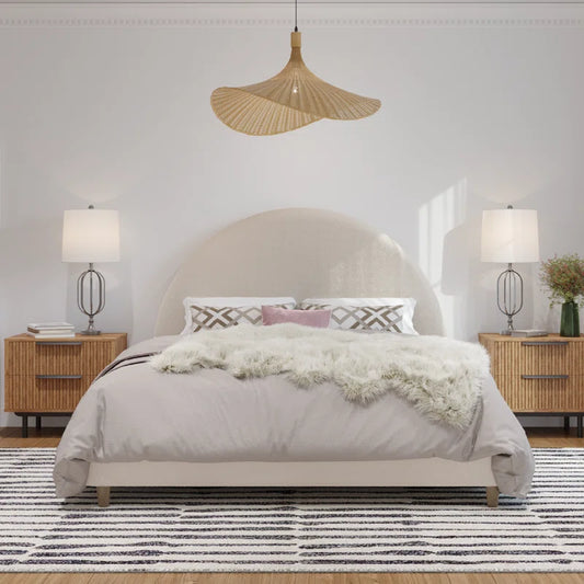 Modern bedroom with a bed, nightstands, and lamps.