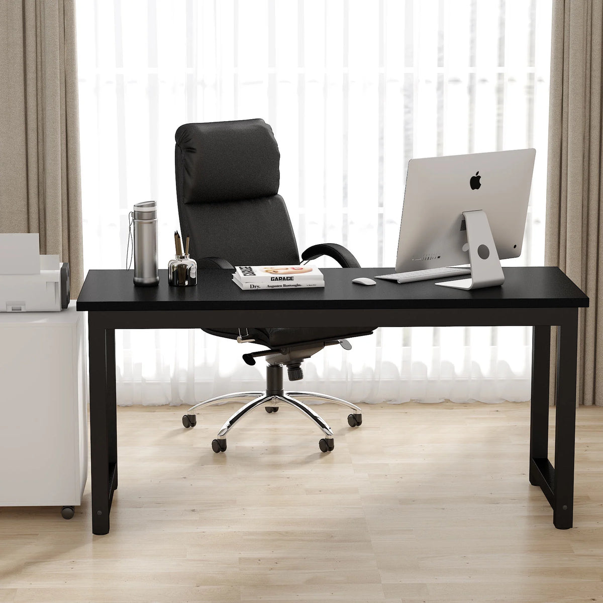Modern office desk with chair and computer setup in a bright room.