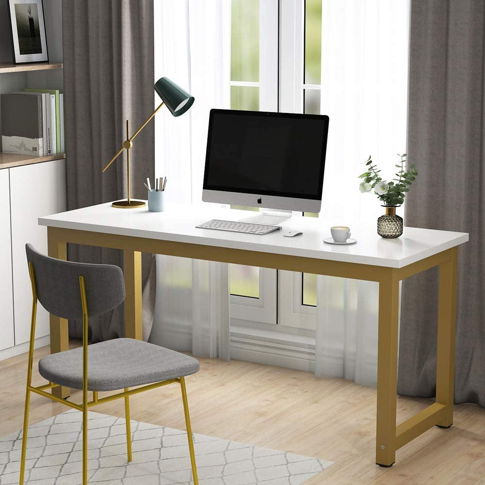 Modern home office setup with a white desk, computer monitor, lamp, and chair.