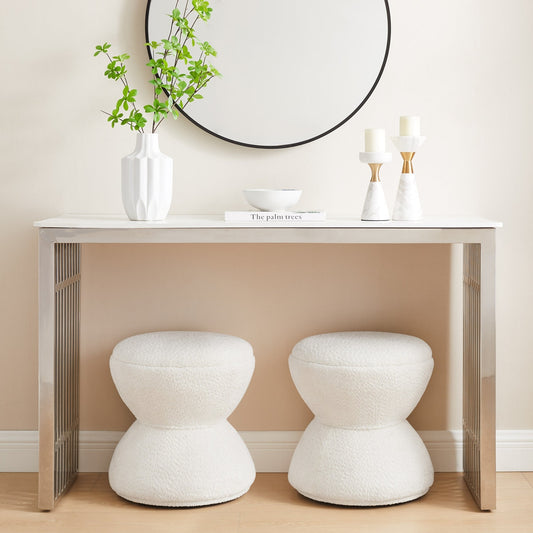 Modern interior with a console table, stools, and decorative items.