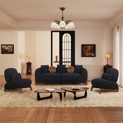 Modern living room with dark blue sofa, armchairs, and wooden coffee tables.