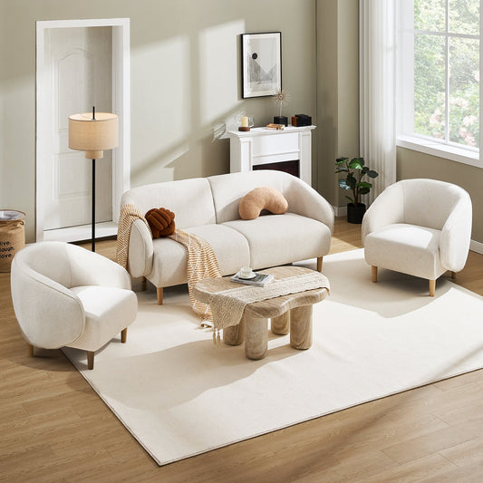 Modern living room with white sofa, chairs, and a wooden coffee table.