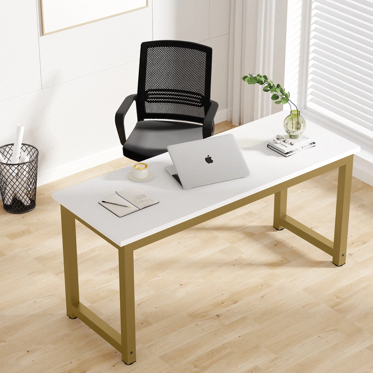 Modern office desk with a laptop, chair, and decor items in a bright room.
