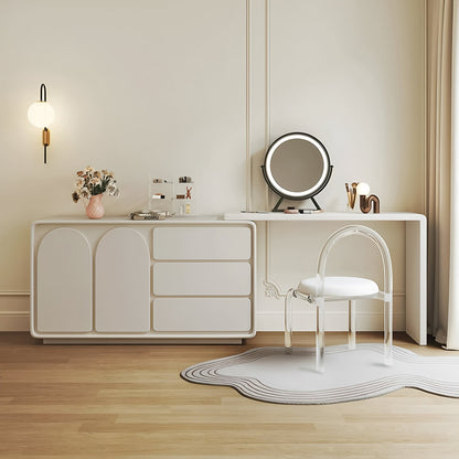 Modern vanity setup with a mirror, chair, and decorative items in a minimalistic room.