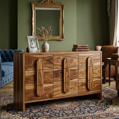 Wooden dresser with decorative items in a room with green walls and a patterned rug.