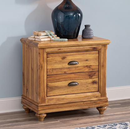 Natural SHEESHAM Wooden nightstand with two drawers against a light blue wall. 
