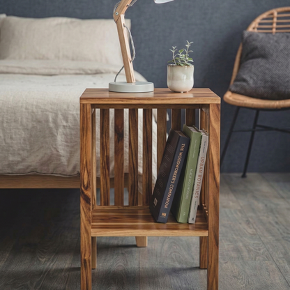 Wooden side table with books and a lamp in a bedroom setting