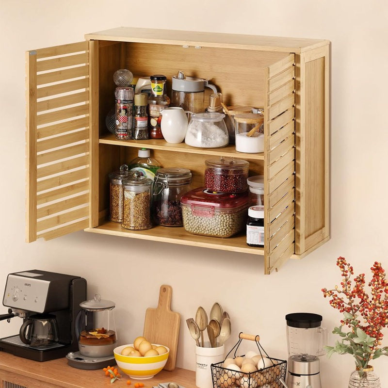 Wooden wall-mounted cabinet with kitchen items on a light-colored wall.